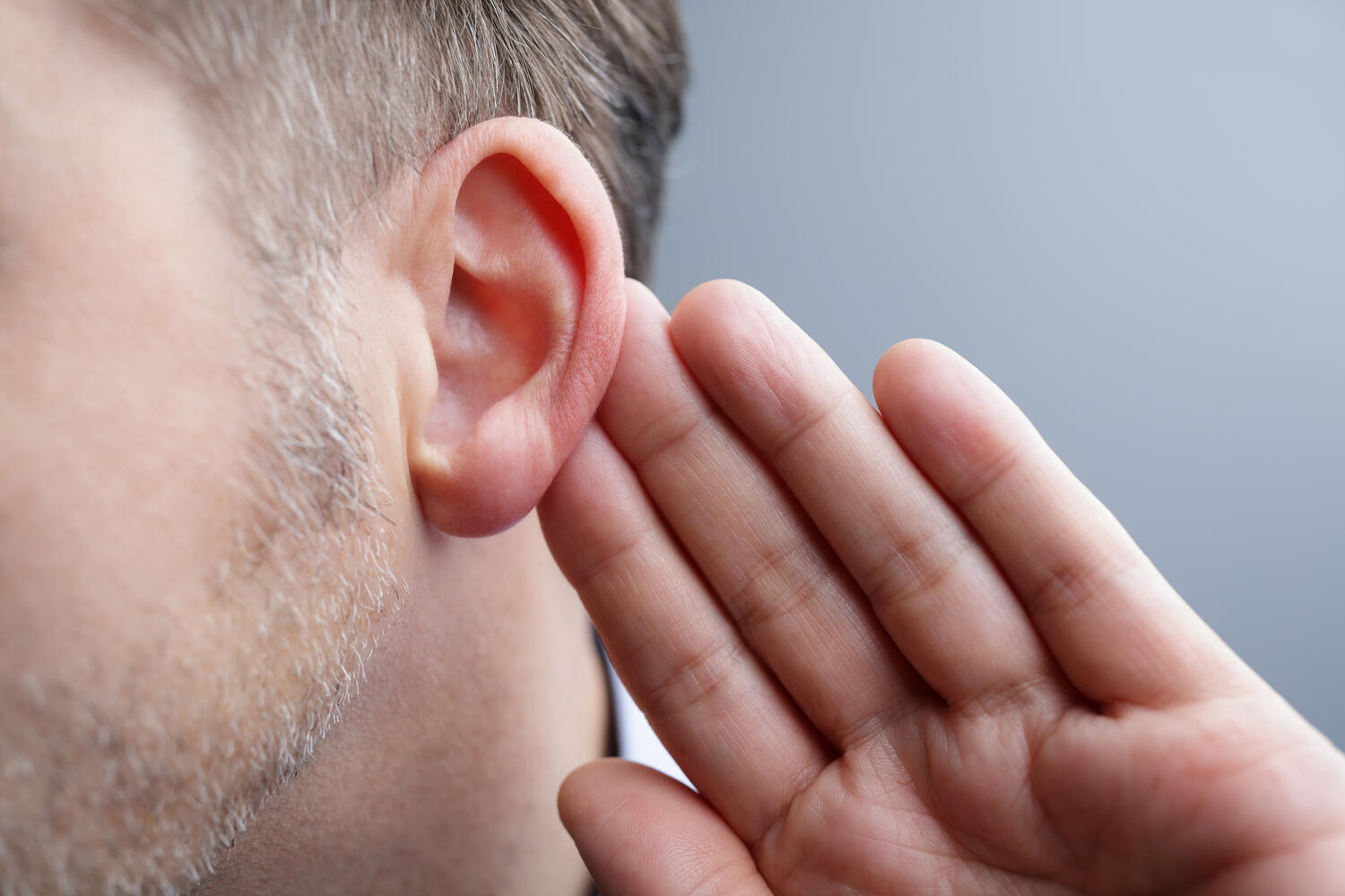 man holding his ear