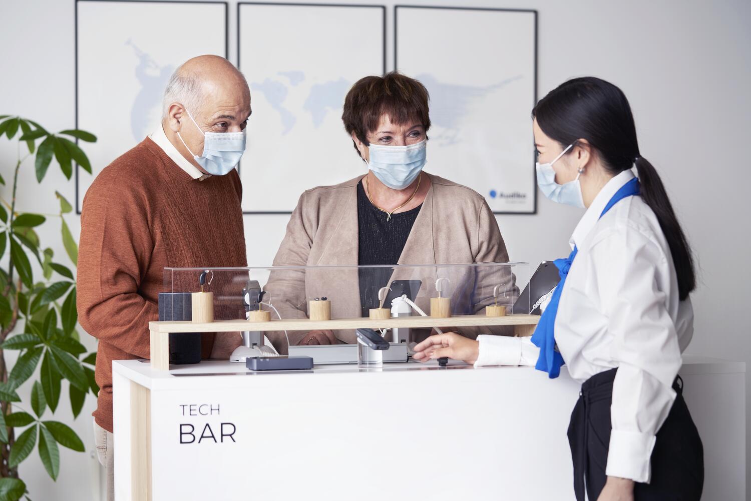 clients looking at hearing aid types in hearing clinic with hearing professional
