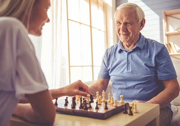 man playing chess with woman