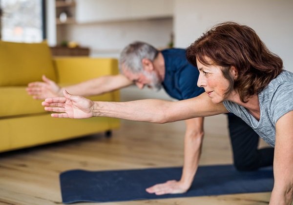 couple doing yoga at home