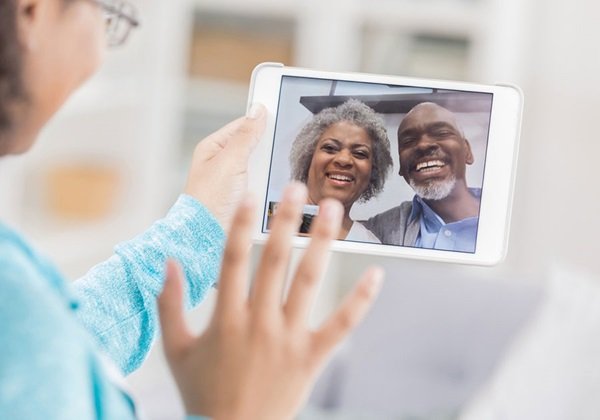 woman talking to friends on a tablet