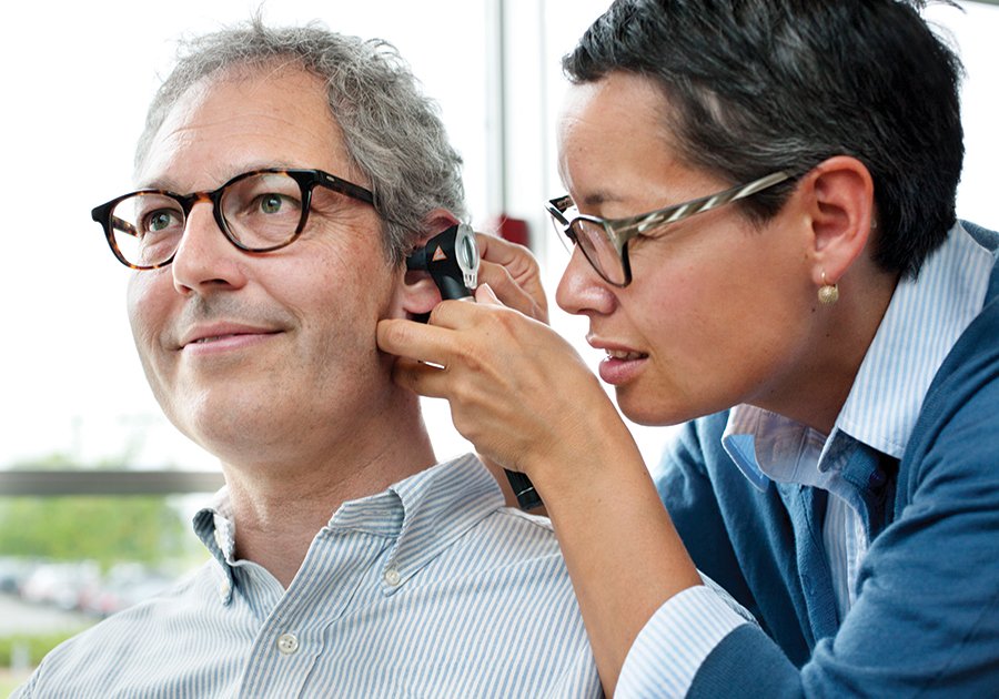 Hearing Practitioner Checking a Man's ear