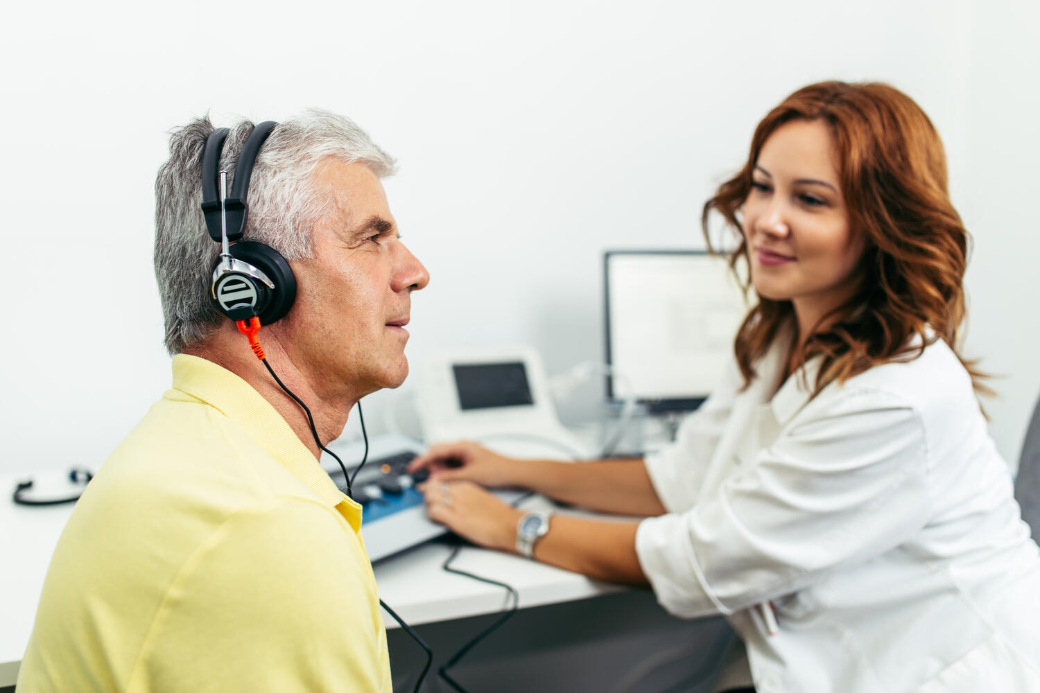 hearing professional performing hearing test on client