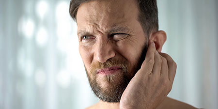 man with discomfort in his ears