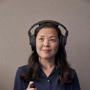 woman smiling while having her hearing tested