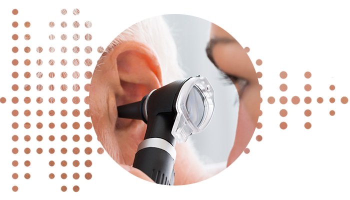 ear being checked for ear wax with an otoscope