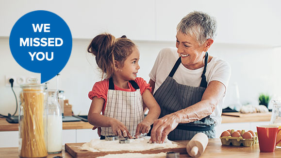 woman and grand daughter cooking together