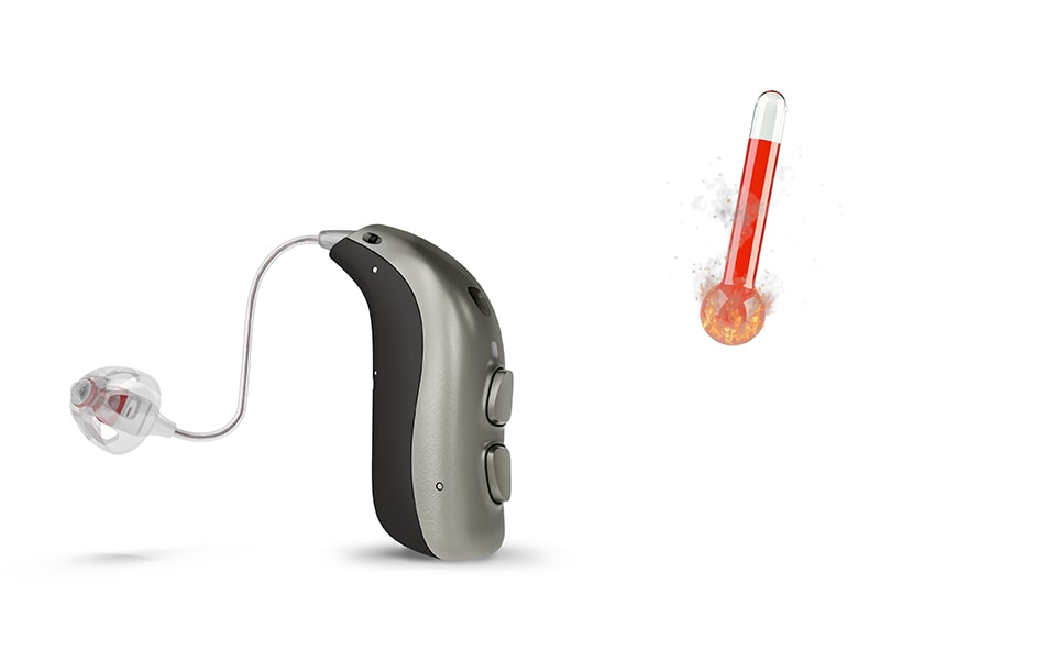 A Bernafon minirite hearing aid next to a thermometer with red bar showing a hot temperature