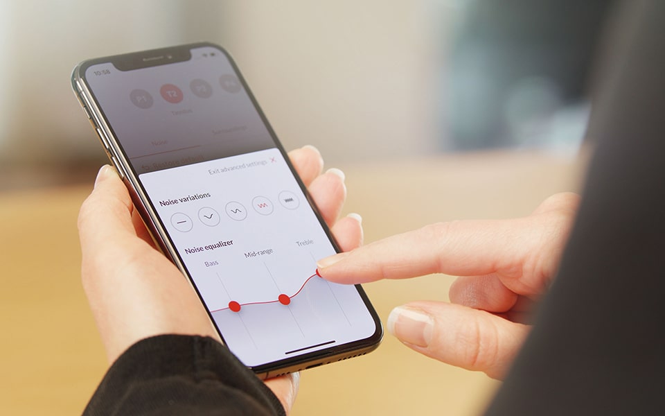 Person holding a smartphone using the Bernafon Bernafon EasyControl-A app for hearing aids