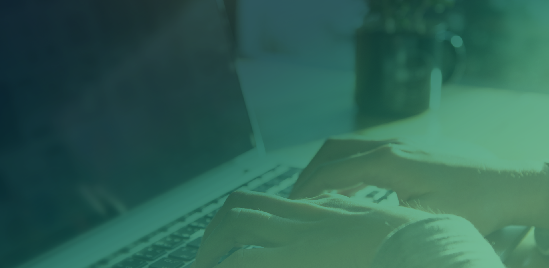 A woman writing on a laptop