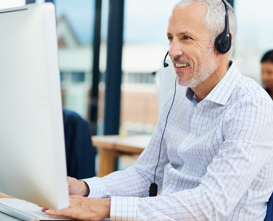 A man from Diatec Diagnostics talking into his headphones, looking into a computer screen