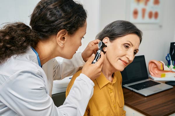 woman-getting-ear-checked-with-otoscope