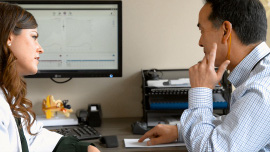 An audiologist counseling a patient after an audiology examination