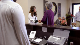 An audiologist greeting a patient