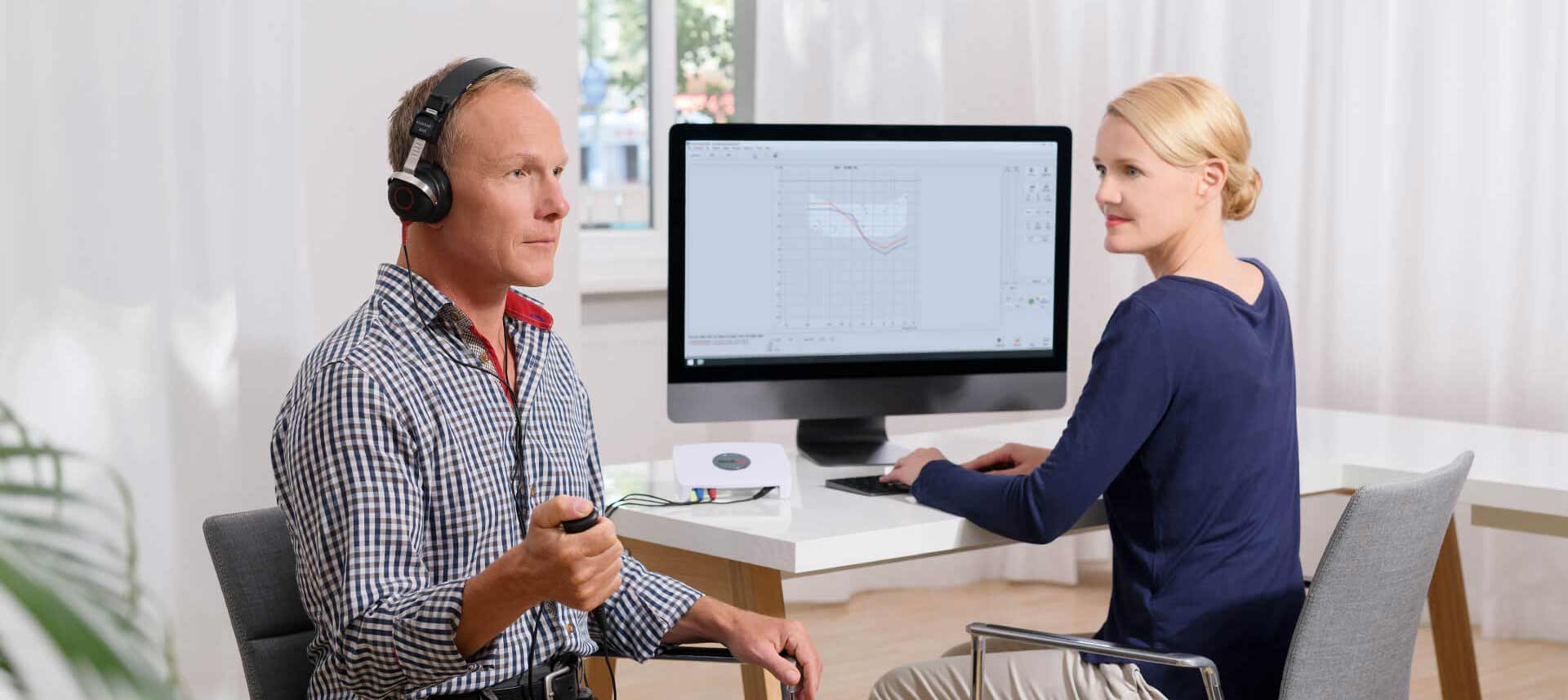 Doctor giving patient a hearing evaluation using the AVANT A2D+ Audiometer